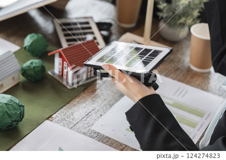 Sustainable Development and Solar Technology. A team reviewing solar technology for improving energy efficiency in homes. Sustainable Development and Solar Technology. A team reviewing solar technology for improving energy efficiency in homes. 124274823