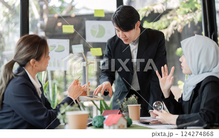 Sustainability and Team Collaboration. A business meeting focused on sustainable practices and environmental solutions among professionals. Sustainability and Team Collaboration. A business meeting focused on sustainable practices and environmental solutions among professionals. 124274868