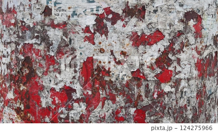 Red painted metal surface with torn pieces of paper and rust Red painted metal surface with torn pieces of paper and rust 124275966