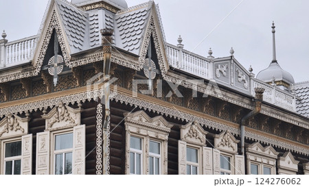 Traditional russian architecture showcasing intricate carvings, decorative metal roofing, and ornate window frames in a detailed exterior view Traditional russian architecture showcasing intricate carvings, decorative metal roofing, and ornate window frames in a detailed exterior view 124276062