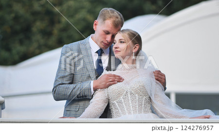 Newlyweds sharing intimate embrace, wedding moment capturing deep emotional connection 124276957