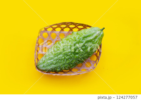 A fresh, green bitter melon (Momordica charantia), a common ingredient in Asian cuisine, ready for preparation 124277057