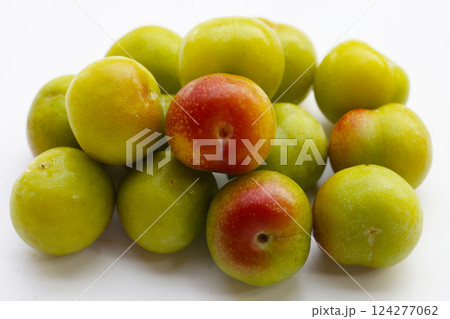 Fresh green plum on white background Fresh green plum on white background 124277062