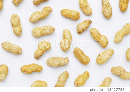 Roasted peanuts in shell on white background. Roasted peanuts in shell on white background. 124277284