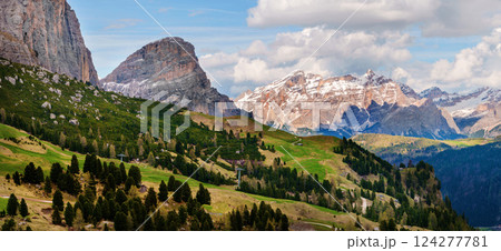 Majestic mountain landscape with lush green valleys and snow-capped peaks near Valley of Funes at Dolomites, Italy 124277781