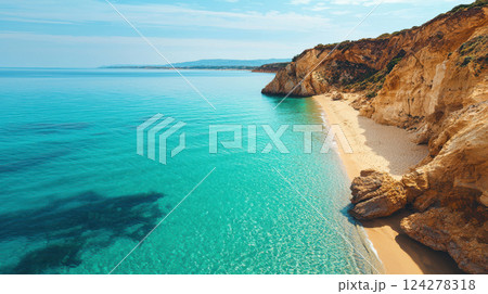 A beautiful beach with a rocky cliff in the background 124278318