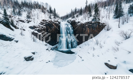 A snow covered mountain with a large waterfall 124278537