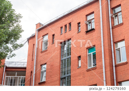 The facade of the old red brick building that was The facade of the old red brick building that was 124279160