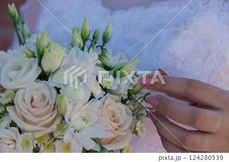 The bride gently strokes the wedding bouquet of The bride gently strokes the wedding bouquet of 124280539