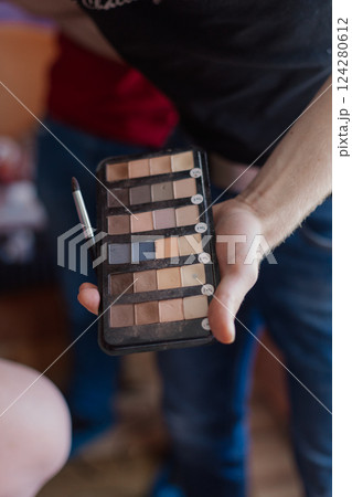 Woman's hand holding make up eyeshadow palette Woman's hand holding make up eyeshadow palette 124280612