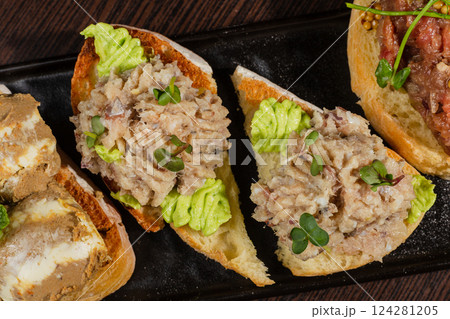 Three types of bruschetta on the table on a black 124281205