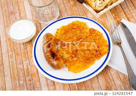 Potato pancakes with sausage and sour cream Potato pancakes with sausage and sour cream 124281547
