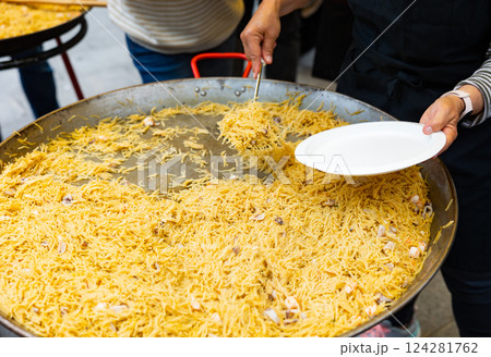 Fideua seafood portions served at street party 124281762