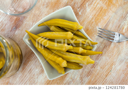 Pickled okra pods on plate, homemade preserves 124281780
