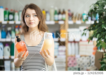 Young woman choosing liquid hand soap Young woman choosing liquid hand soap 124282006