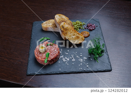 Beef tartare. Cold appetizer of raw marinated meat Beef tartare. Cold appetizer of raw marinated meat 124282012