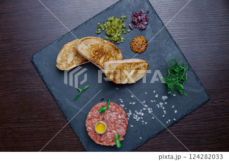 Beef tartare. Cold appetizer of raw marinated meat 124282033