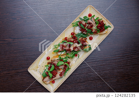 Appetizing sandwiches with meat, greens and Appetizing sandwiches with meat, greens and 124282135