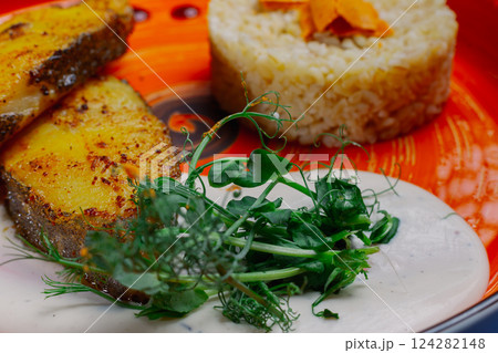 Grilled fresh red fish lies on a plate along with 124282148