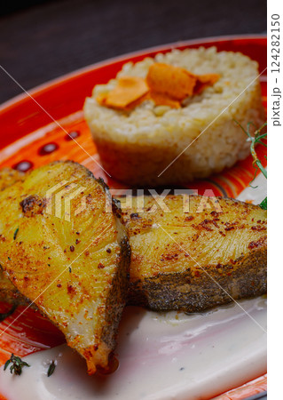 Grilled fresh red fish lies on a plate along with Grilled fresh red fish lies on a plate along with 124282150