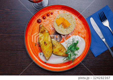 Grilled fresh red fish lies on a plate along with 124282167