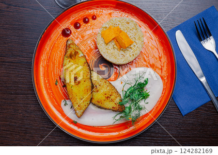 Grilled fresh red fish lies on a plate along with Grilled fresh red fish lies on a plate along with 124282169