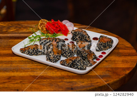 Grilled red fish meat with sesame seeds. A plate 124282940