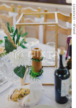Wedding table decor. Candle on the table with live Wedding table decor. Candle on the table with live 124283015