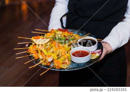 Shish kebab from seafood and red fish on wooden Shish kebab from seafood and red fish on wooden 124283101