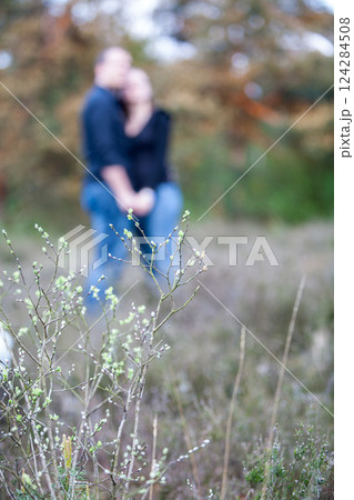 A couple in a warm embrace in nature, captured with soft focus to enhance romance 124284508