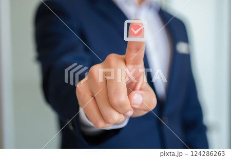 Businessman hand touching virtual checkmark button success confirmation approval concept modern technology digital interface professional achievement complete task agreement 124286263