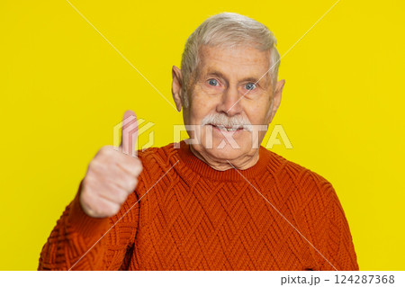 Senior man raises thumbs up agrees or gives positive reply recommends advertisement likes good idea Senior man raises thumbs up agrees or gives positive reply recommends advertisement likes good idea 124287368