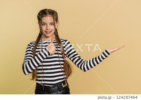 Child girl kid showing thumbs up and pointing on blank space place for advertisement promotion logo Child girl kid showing thumbs up and pointing on blank space place for advertisement promotion logo 124287464