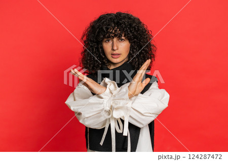 Woman says no hold palm folded crossed hands in stop gesture warning of finish prohibited access Woman says no hold palm folded crossed hands in stop gesture warning of finish prohibited access 124287472