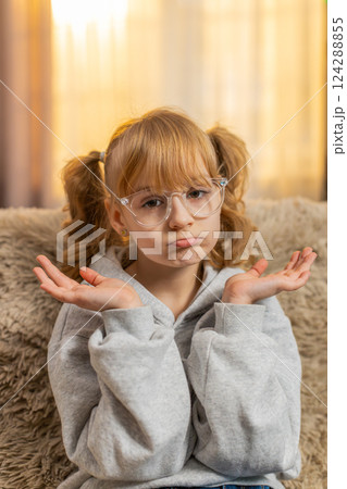 Confused teenager girl feeling embarrassed about ambiguous question, having doubts, no idea 124288855