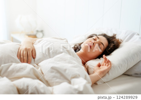 Woman is sleeping in her bedroom 124289929