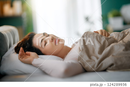 Woman is sleeping in her bedroom 124289936