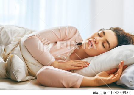 Woman is sleeping in her bedroom Woman is sleeping in her bedroom 124289983