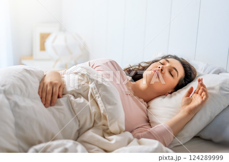 Woman is sleeping in her bedroom 124289999