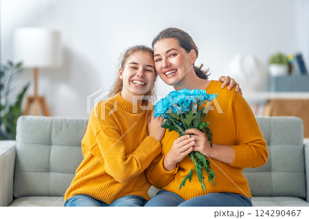daughter is congratulating mom and giving her flowers daughter is congratulating mom and giving her flowers 124290467