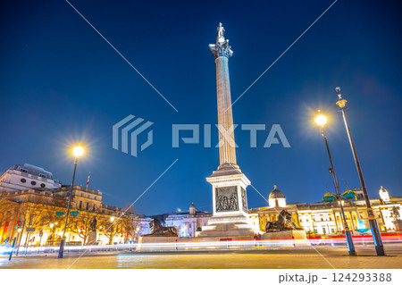 Nelson's Column stands tall in Trafalgar Square at night, illuminated by street lights. The monument commemorates Vice-Admiral Horatio Nelson's victory at the Battle of Trafalgar. 124293388