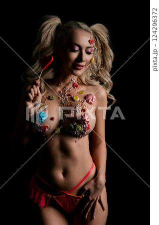 Beauty showcase with a woman in colorful sweets and tattoos 124296372