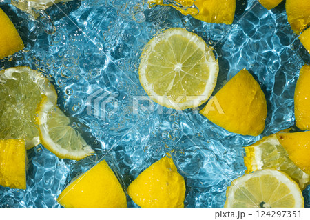 Refreshing citrus background with floating lemon pieces Refreshing citrus background with floating lemon pieces 124297351