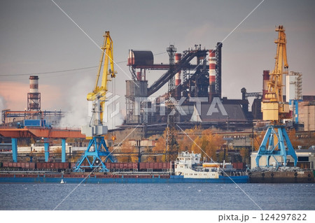 Blast furnace, Metallurgical plant in sunset light. Industrial port with cranes on the river bank. Environmental problems 124297822
