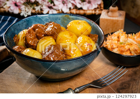 Beef stew in gravy, served with silesian dumplings. 124297923