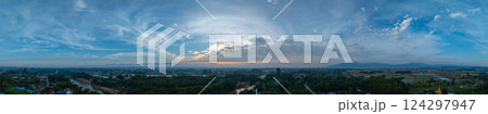 Aerial view of Clouds streak the sunlight above unban village. 124297947