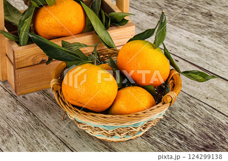 Ripe sweet tangerines heap with leaves 124299138