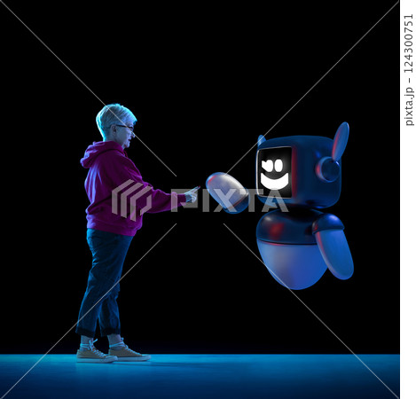 Composite image of elderly woman interacting with 3D model of robot, expressing cross-generational trust in artificial intelligence. 124300751