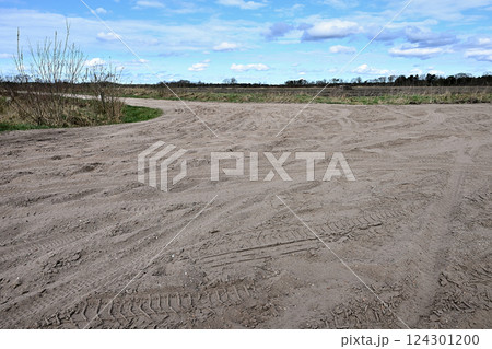 Multiple Bicycle tire tracks  in a sandy road 124301200
