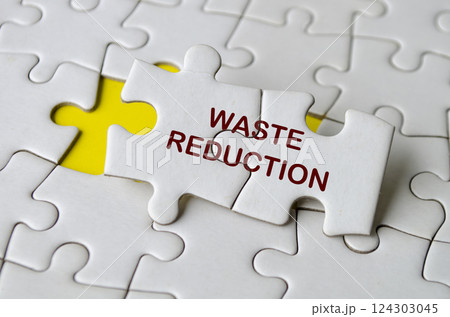 Waste Reduction text on jigsaw puzzle. Process improvement concept Waste Reduction text on jigsaw puzzle. Process improvement concept 124303045